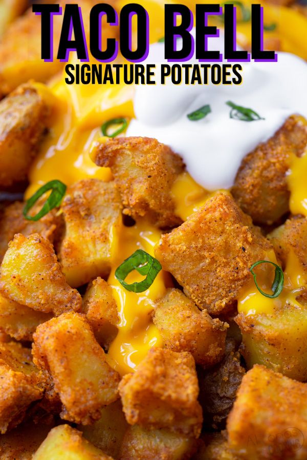 a close up of food on a plate with the words taco bell signature potatoes