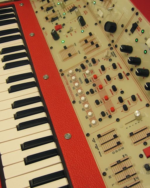 an electronic keyboard sitting on top of a red table