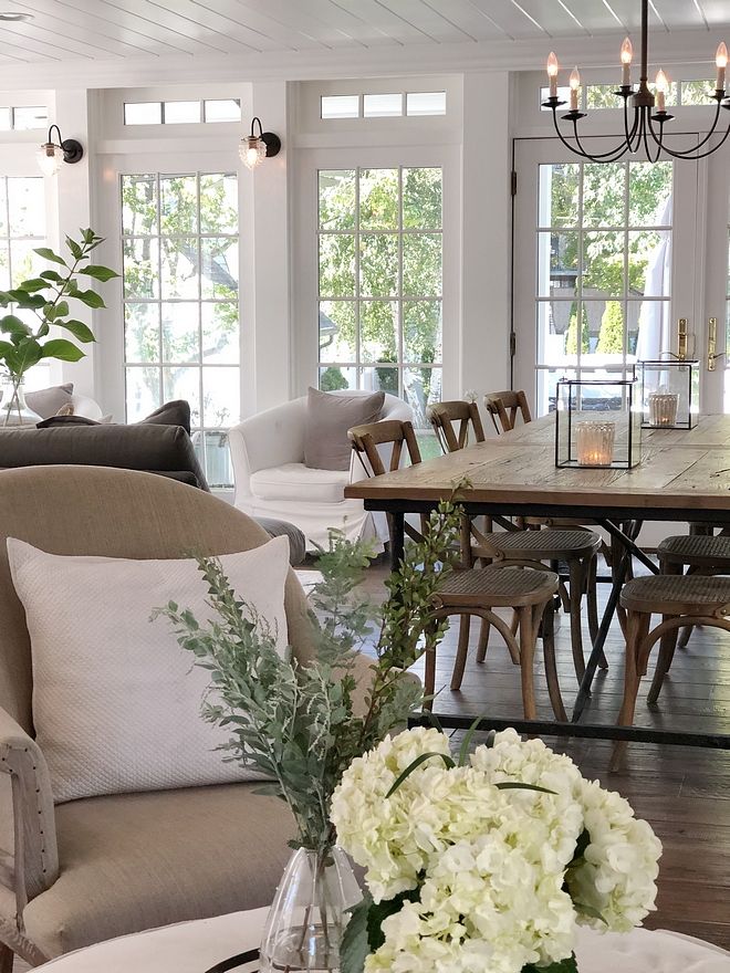 a living room filled with lots of furniture and flowers on top of a coffee table