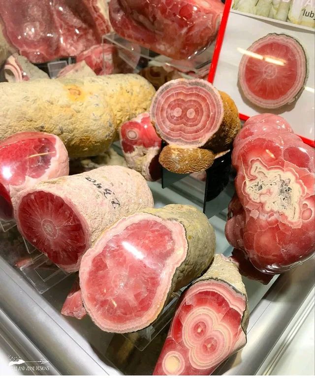 raw meats are displayed in a display case