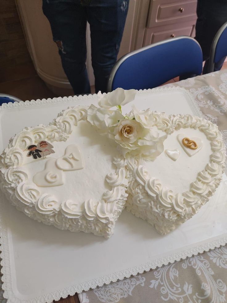 two heart shaped wedding cakes on a table