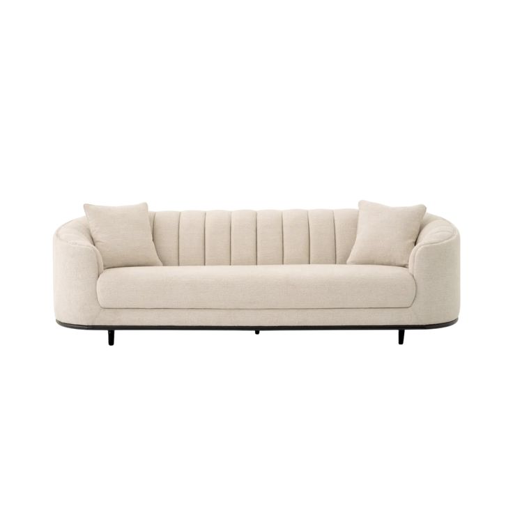 a white couch with two pillows on it