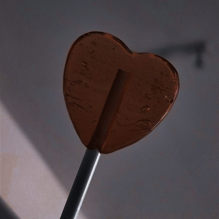 a chocolate heart shaped lollipop on a stick