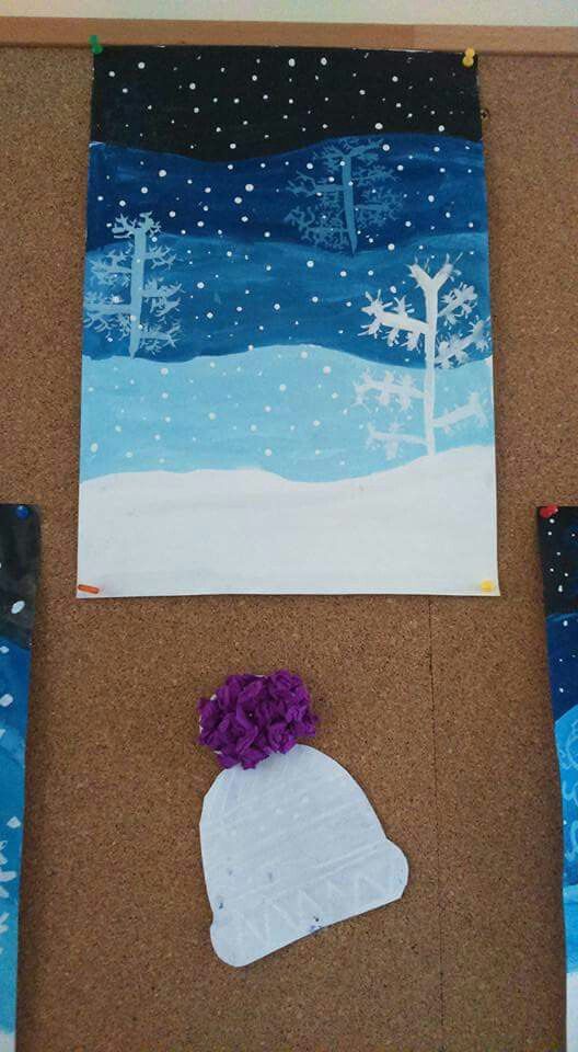 art work displayed on cork board with snow scene