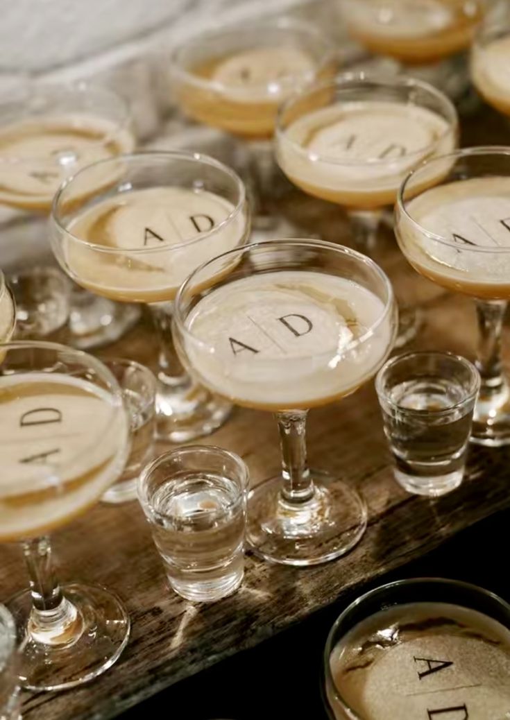 many glasses are lined up on a table