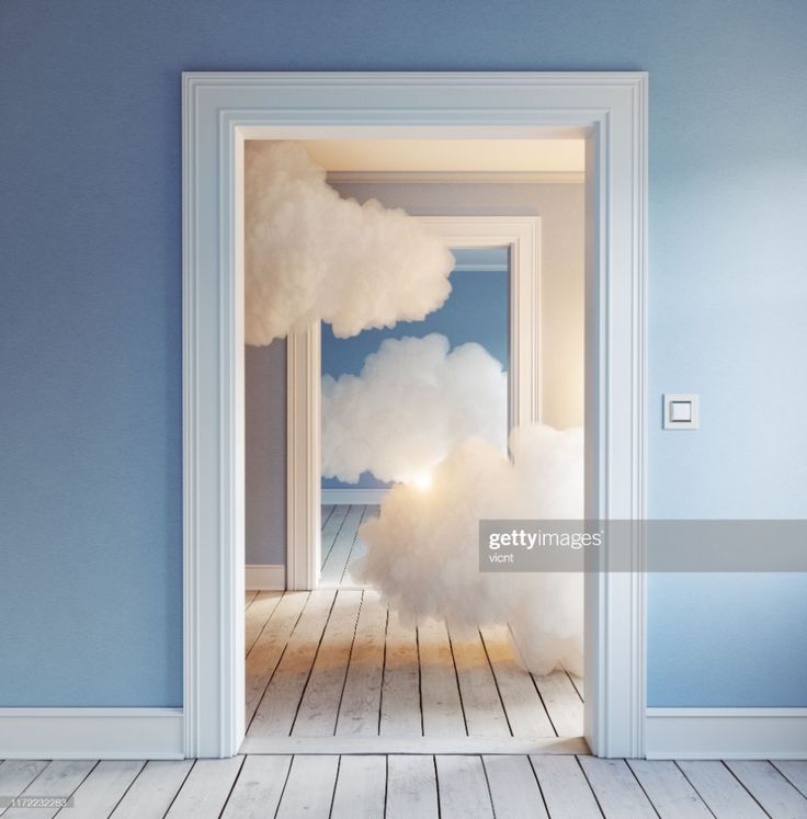 an open door leading into a room with white fluffy clouds on the wall and wood flooring