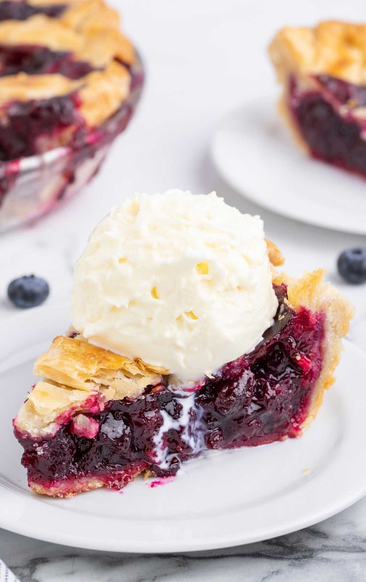 a slice of blueberry pie with ice cream on top