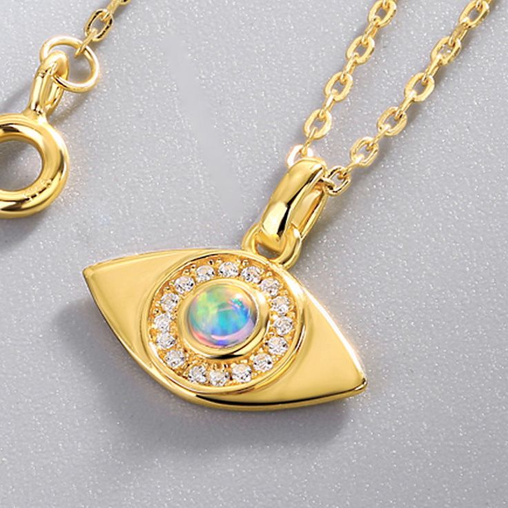 Gorgeously crafted in shimmering gold atop sterling silver, our Opal Evil Eye Necklace is a must-have accessory for adding a hint of elegance to any everyday look. Stunningly saturated opal is accompanied by the symbol of the Evil Eye, set to bewitch admirers and protect its wearer from ill fate. Perfect for gifting, it is an exquisite token of your love. DETAILS Plating: 10K Gold Materials: 10K Gold  on   Silver, Simulated Opal Measurements :     Length: 15.75"(40cm) + Extender: 1.97"(5.0cm) Pe Silver Gold-plated Necklace With Polished Finish, Fine Jewelry Silver Charm Necklace, Gold Plated, Gold Charm Necklaces In Elegant Style, Fine Jewelry Gold Plated Silver Charm Necklaces, Fine Jewelry Silver Gold-plated Charm Necklace, Gold Charm Necklace As A Gift With Polished Finish, Gold Charm Necklaces With Polished Finish For Gift, Gold Plated Charm Necklaces With Polished Finish For Gift, Gold Charm Necklace With Delicate Sterling Silver Chain