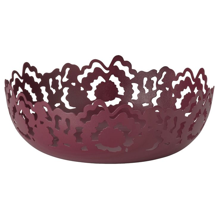 a purple bowl with cut out flowers on the bottom and sides, sitting in front of a white background