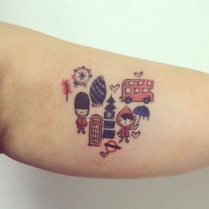 a small tattoo on the arm of a girl with various things in it's heart