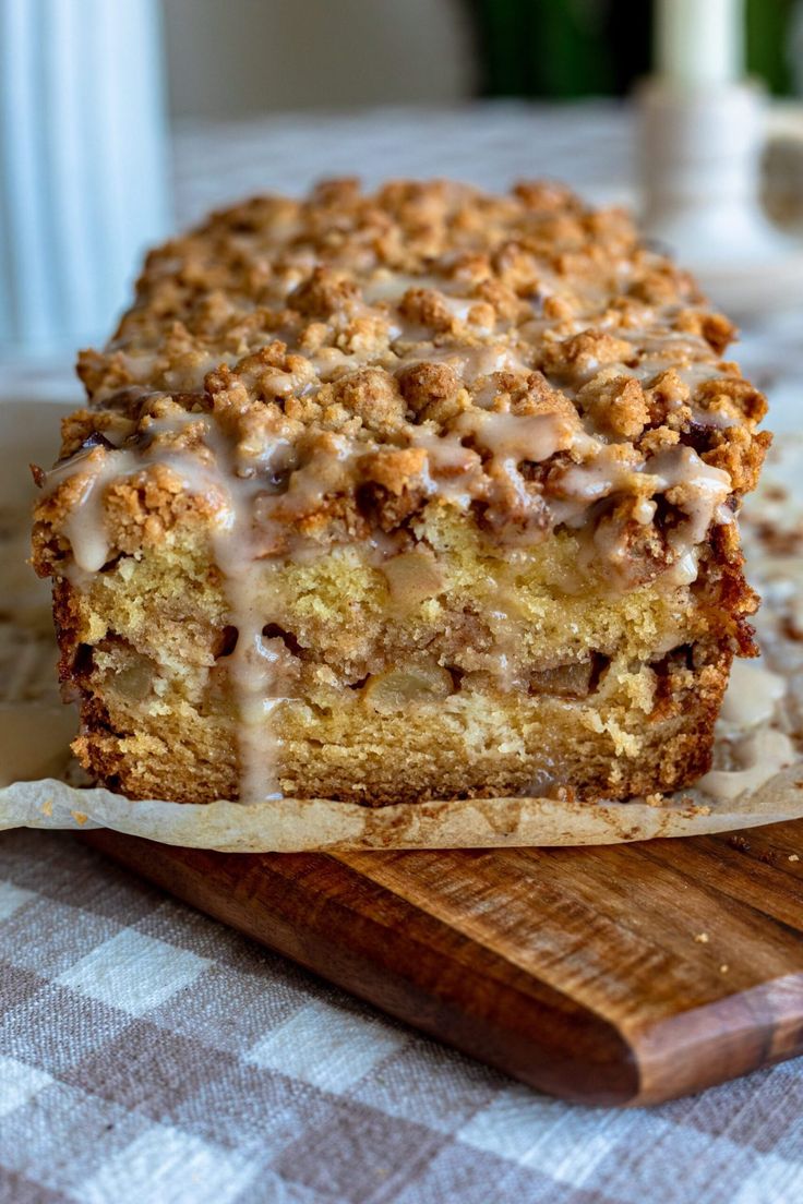 a piece of cake sitting on top of a wooden cutting board