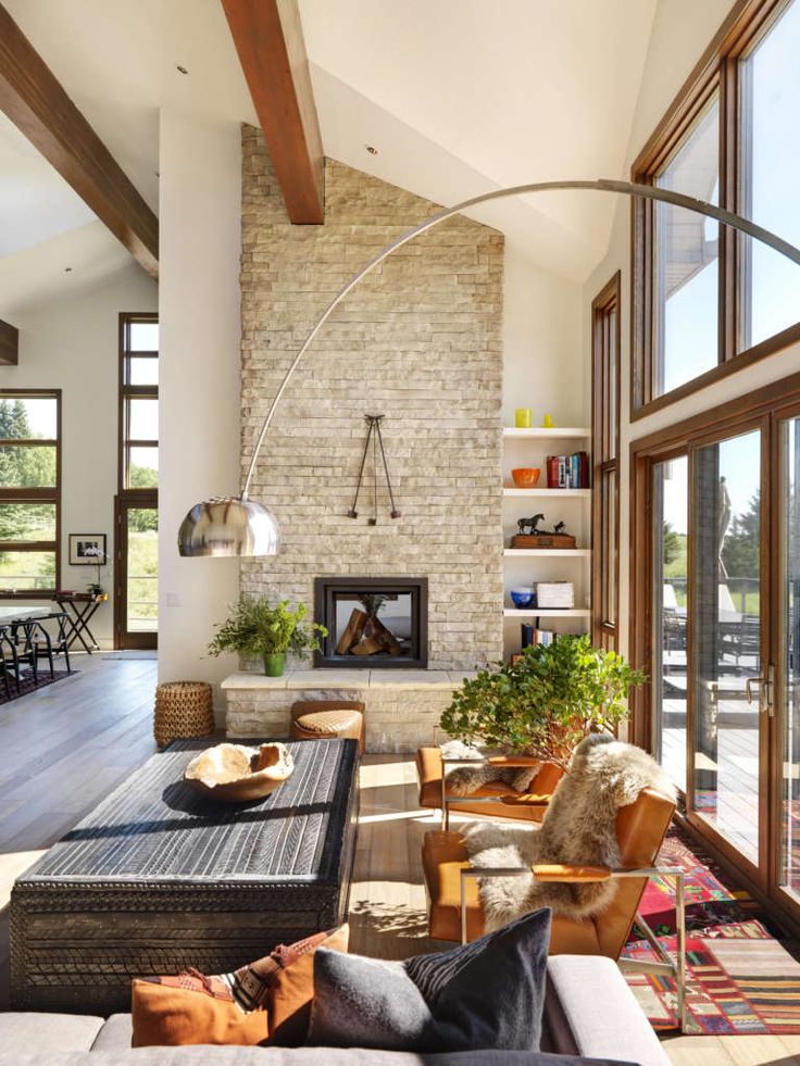 a living room filled with furniture and lots of windows