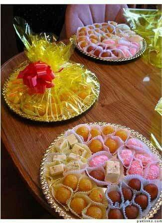 two plates filled with desserts on top of a wooden table next to each other