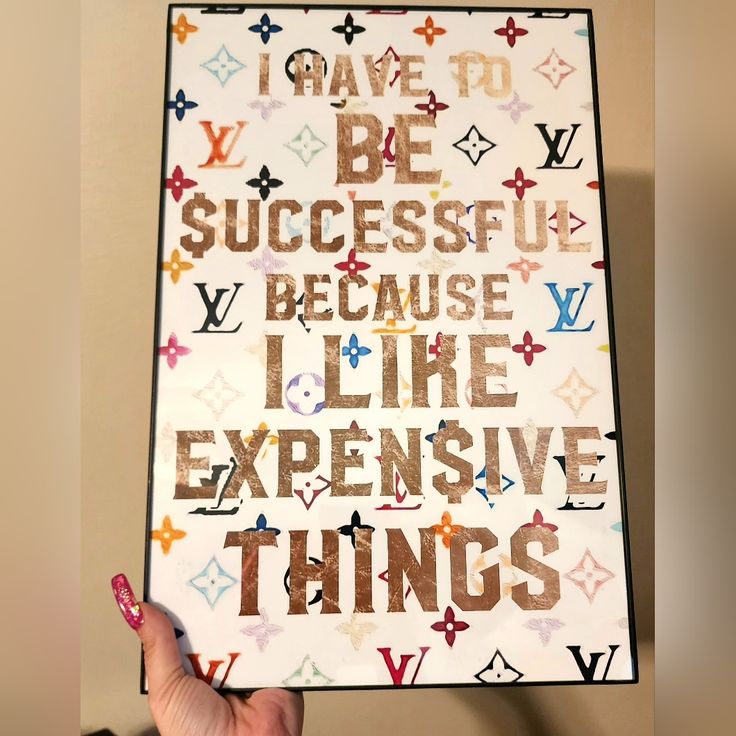 someone holding up a poster with the words i have to be successful because i like expensive things