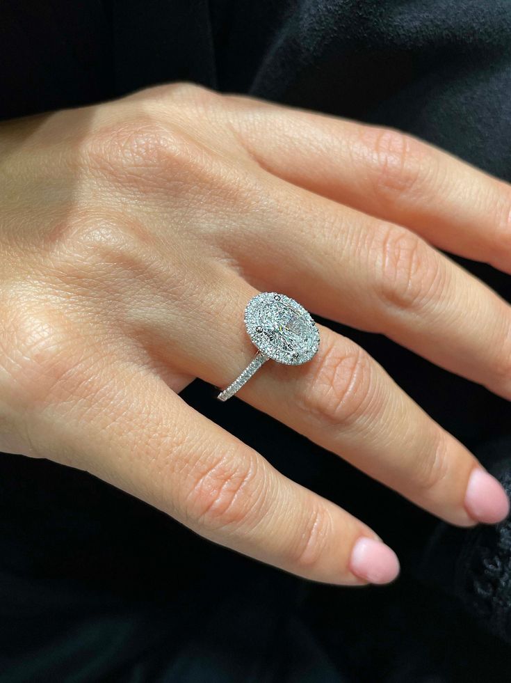 a woman's hand with a diamond ring on it