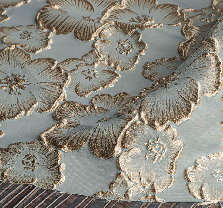 a close up view of the fabric with gold flowers on it