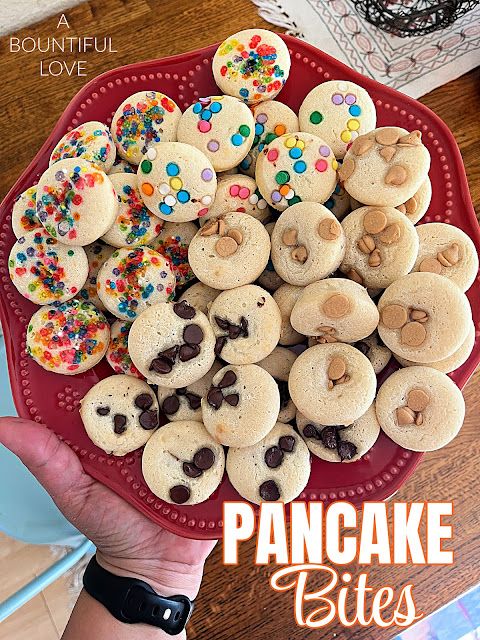 a red plate topped with cookies and sprinkles on top of a wooden table