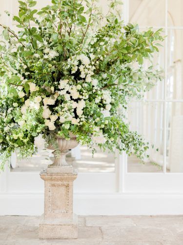 a vase filled with white flowers on top of a table