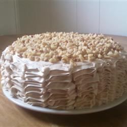 a white cake sitting on top of a wooden table