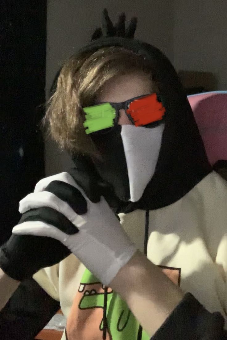 a person wearing a mask and gloves