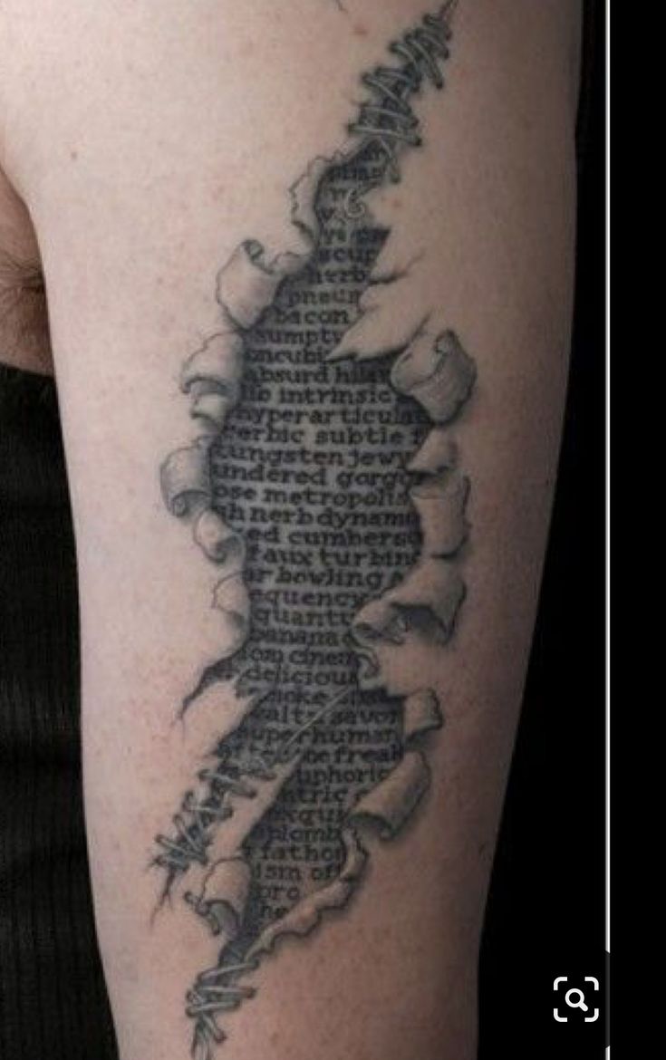 a man with a tattoo on his arm that has words written in the shape of a map