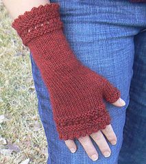 a woman's hand wearing a red knitted mitt on her left arm