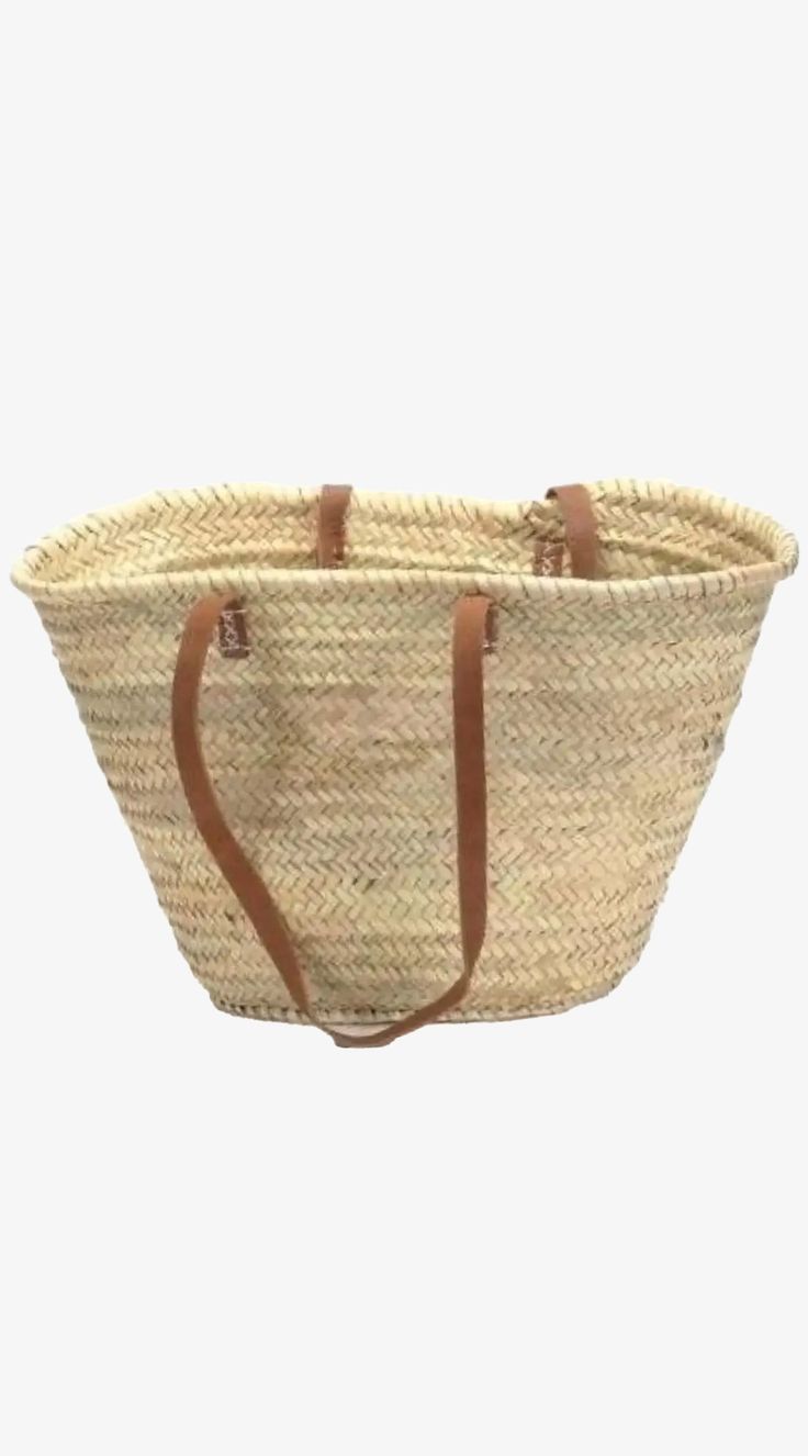 This French Market Basket is our ultimate must-have! Bring to you our greatest find from the markets of Mallorca and South of France, now available on our website. Our favorite summer bag is functional and chic, great for going to the beach, shopping at farmer's market, and strolling around in the Hamptons. Carry your chic and practical bag to the plane and once you get to your sunny destination, switch the content for sunscreen, beach towel, and light reading, and head to the beach! Don't forget your sunglasses! The long leather straps make it easy to carry over your shoulder and it easily fits under the front seat of the plane. Long leather handles Leather tabs finish the attachment of the handles for extra sturdiness Handwoven from palm leaves Average Size: 12" high x 18" across Due to Spring Market Bags With Leather Handles, Shopping Straw Bag With Leather Handles, Summer Market Bag With Adjustable Strap, Beach Tote With Leather Handles, Leather Handle Tote Beach Bag For Market, Leather Handled Tote Beach Bag, Summer Market Bucket Straw Bag, Summer Beach Bag In Natural Color For Everyday Use, Large Capacity Bag For Market In Summer