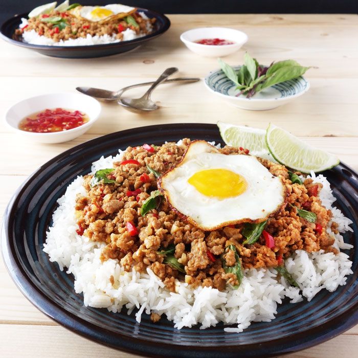 a plate with rice, meat and an egg on top