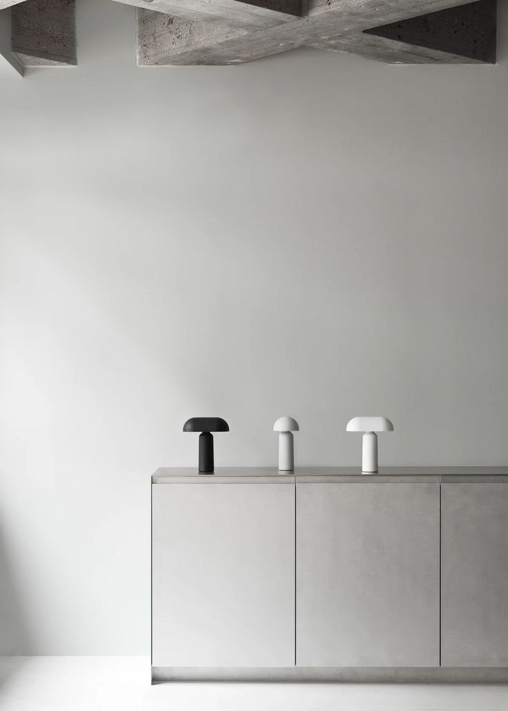 three black and white faucets sitting on top of a counter in a room