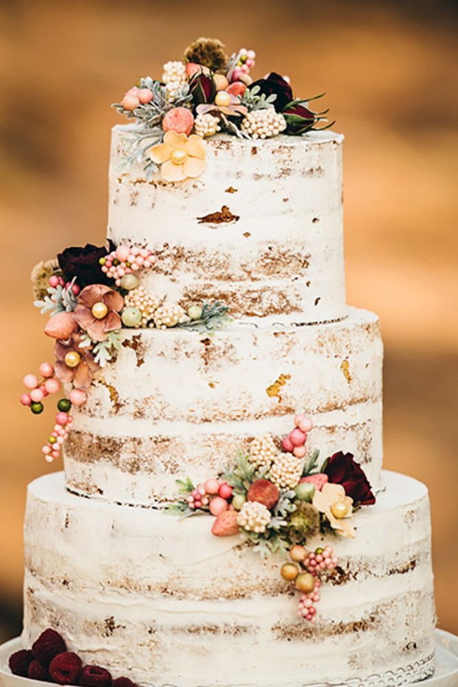 a white wedding cake with flowers on top