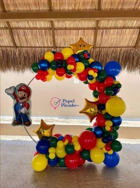 the balloon arch is decorated with mario and balloons