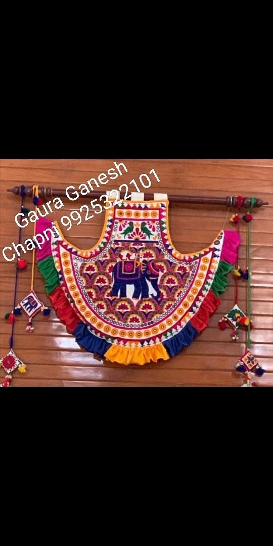 an elephant is hanging on the wall next to other items and decorations, including garlands