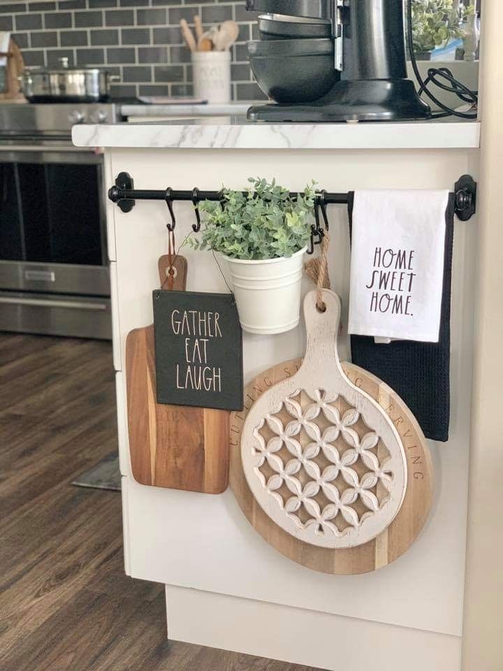 kitchen utensils and cutting boards are hanging on the wall in front of the stove