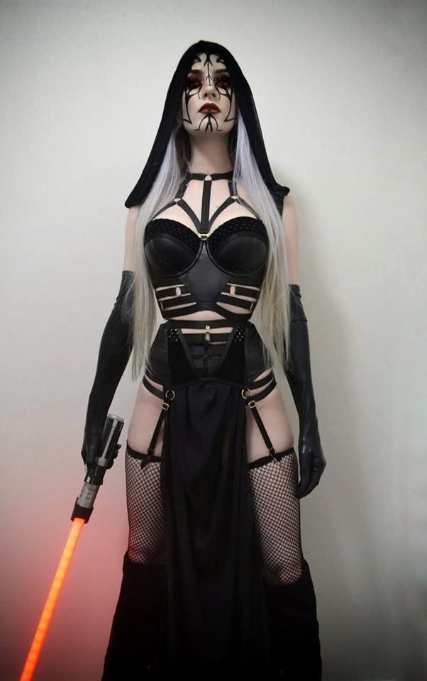 a woman with white hair and black makeup is dressed up as darth vader