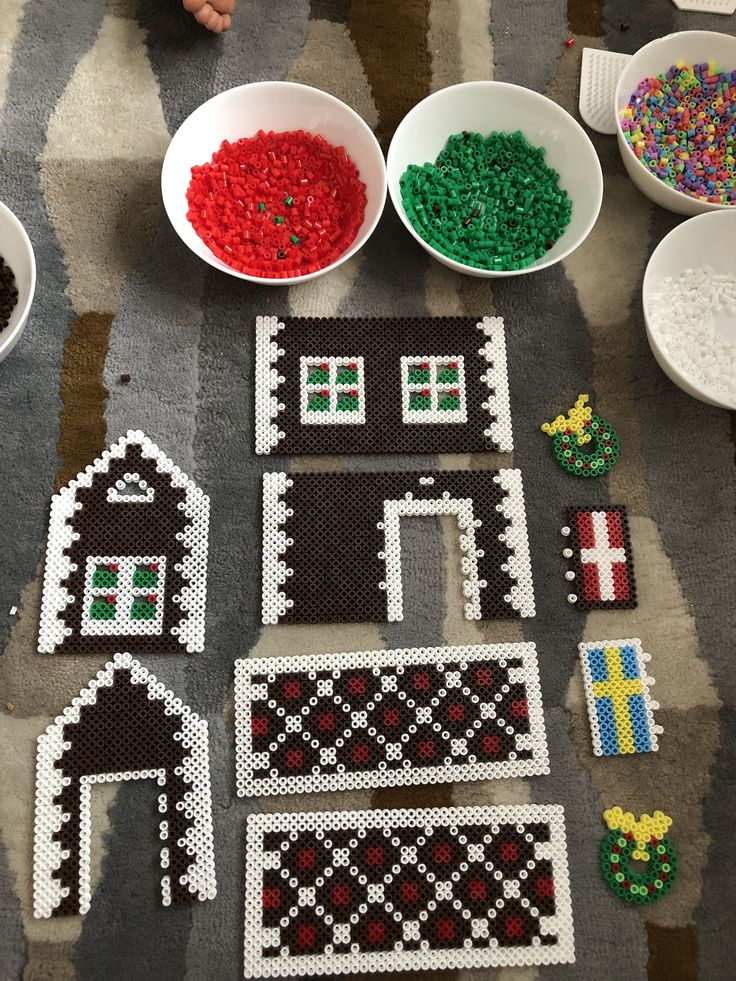 several bowls and plates with bead designs on them sitting on a table next to other beads