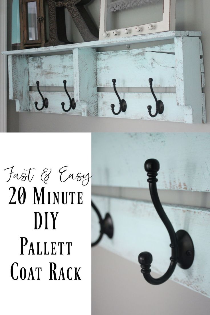 an old pallet coat rack is painted white and has hooks on it