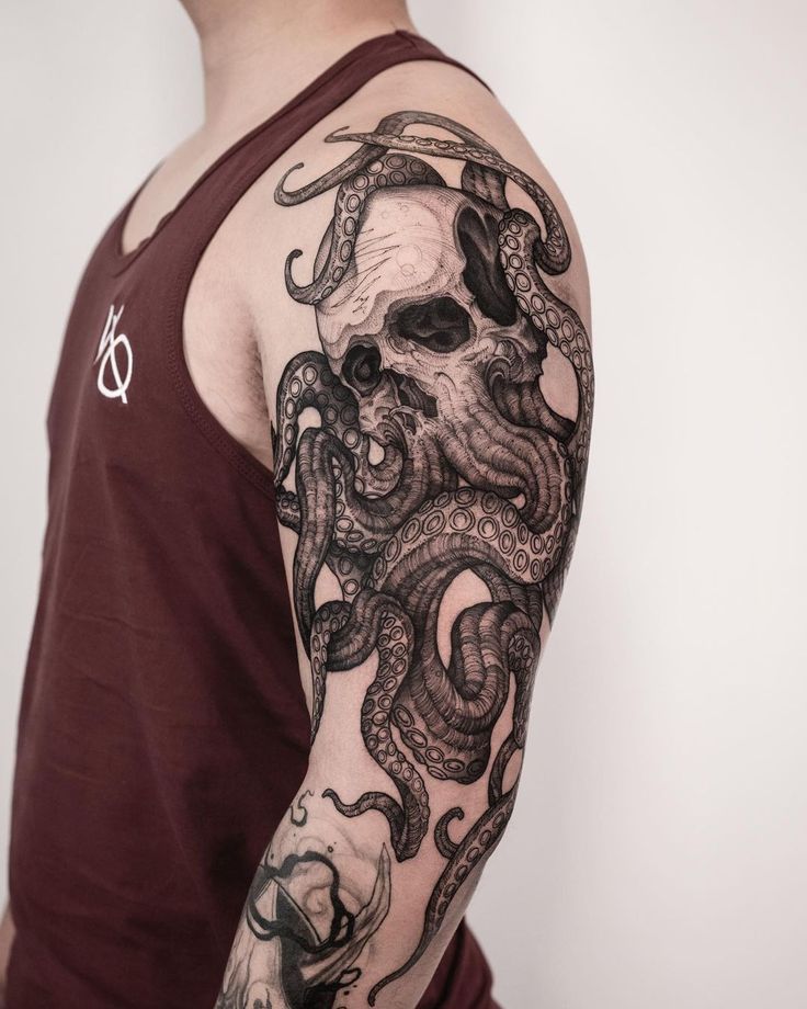 a man wearing a sleeve tattoo with an octopus on it