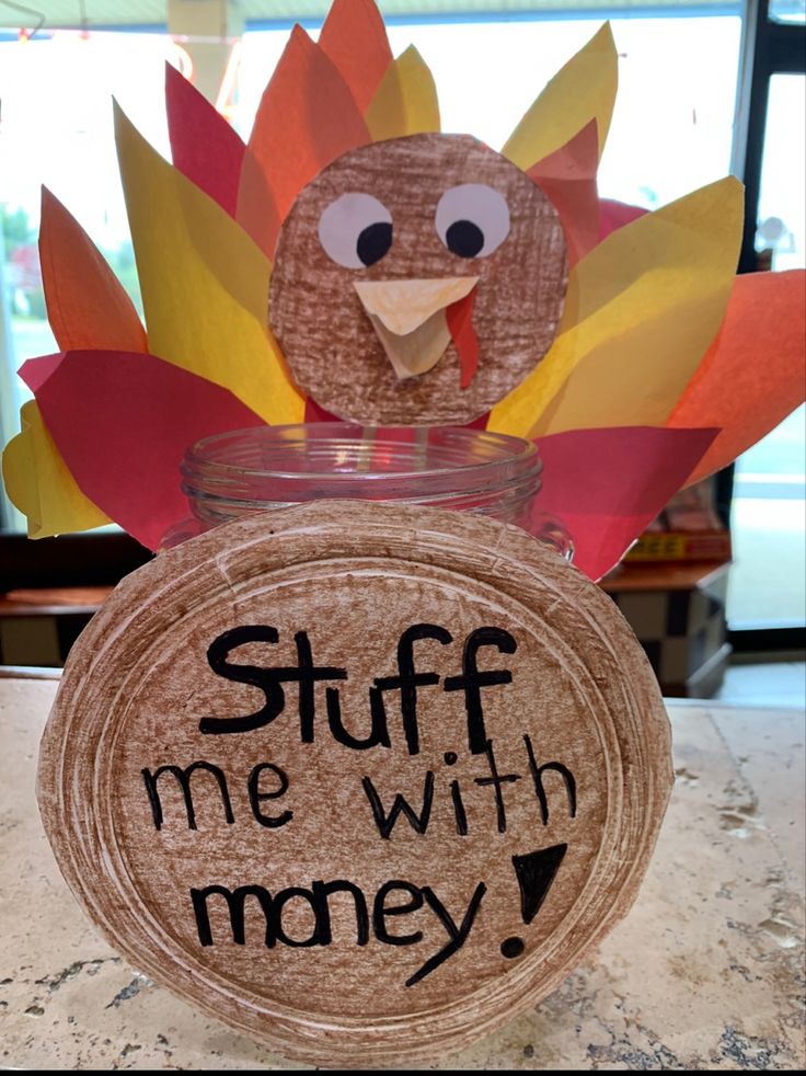 a turkey sitting in a jar with the words stuff me with money on it