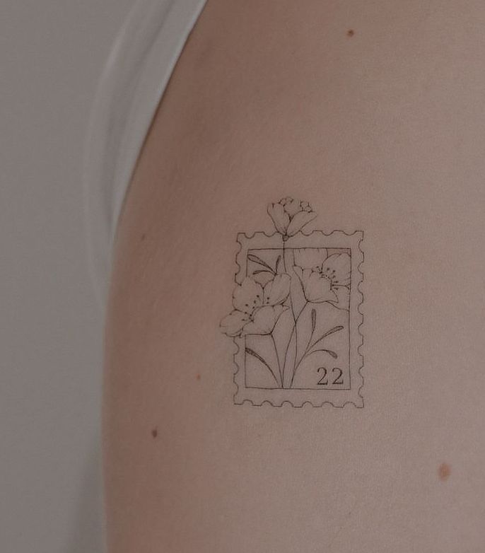 the back of a woman's shoulder with a stamp on it that has flowers