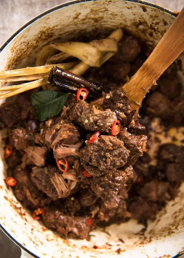 a pot filled with meat and vegetables on top of a table