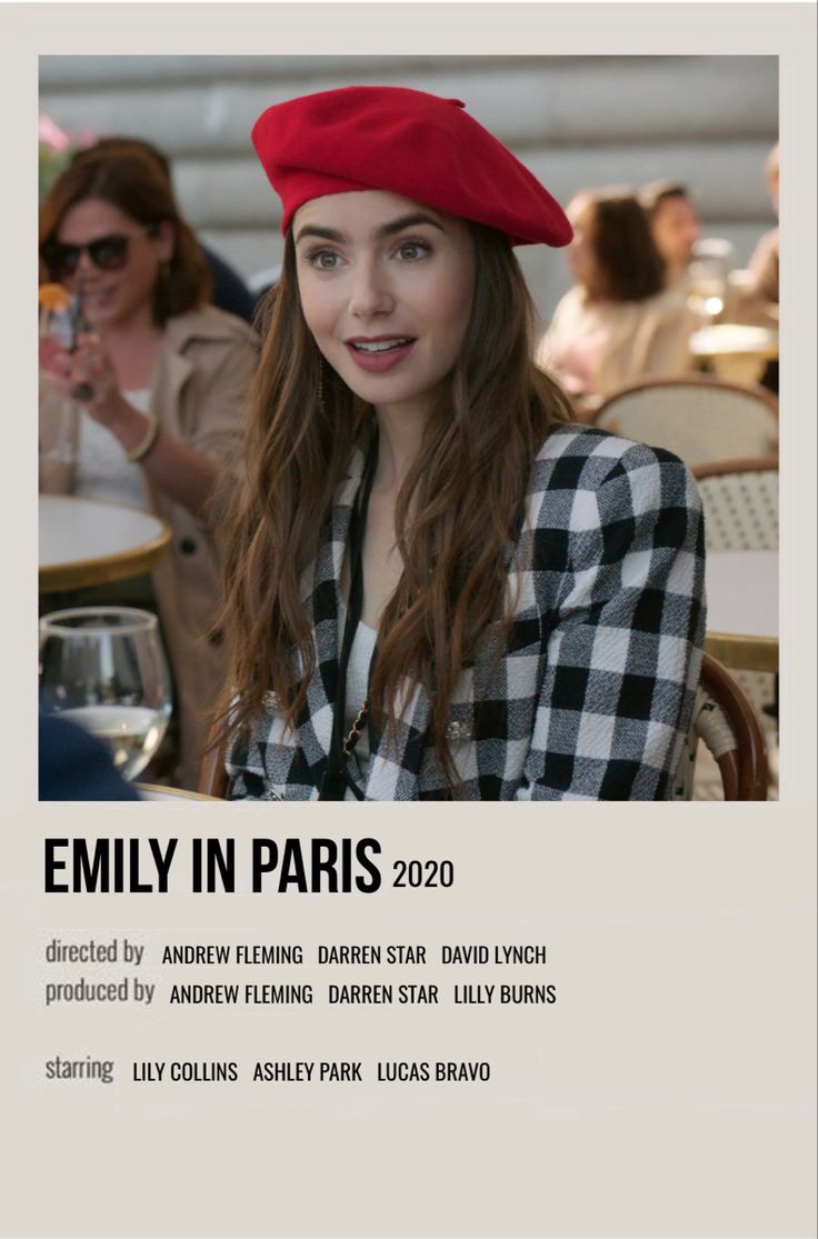 a woman wearing a red beret sitting at a table with people in the background