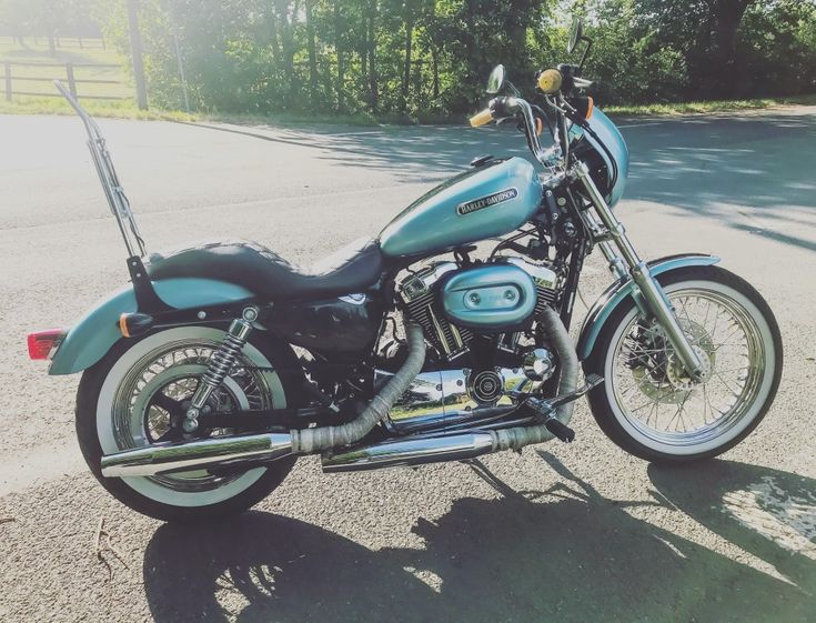 a blue motorcycle is parked on the street