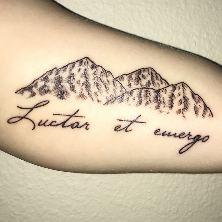 a tattoo with the words futar et energo written in cursive font