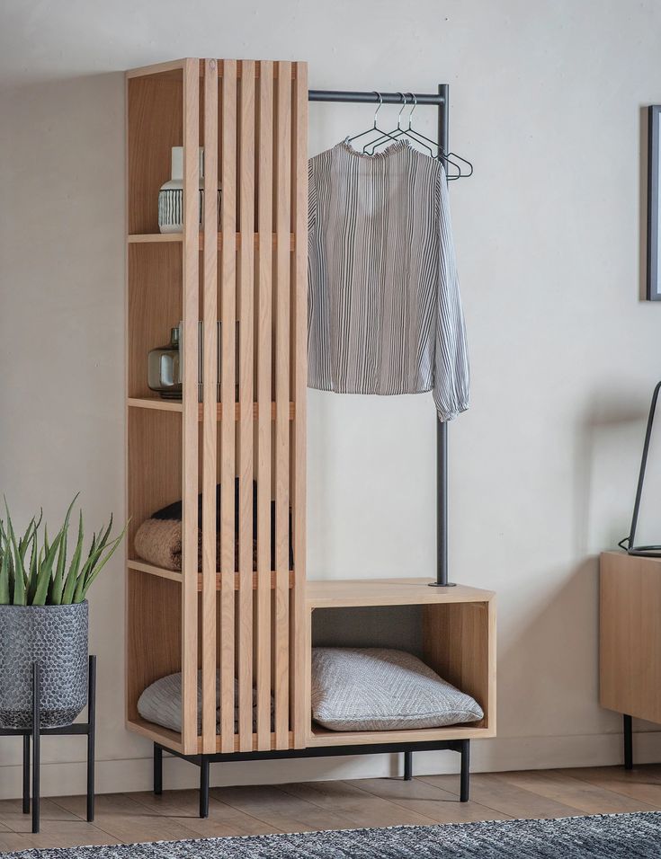 a room with a wooden shelf next to a bed and a plant in a pot