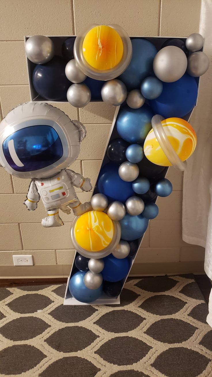 the letter z is made up of balloons and an astronaut's face on it