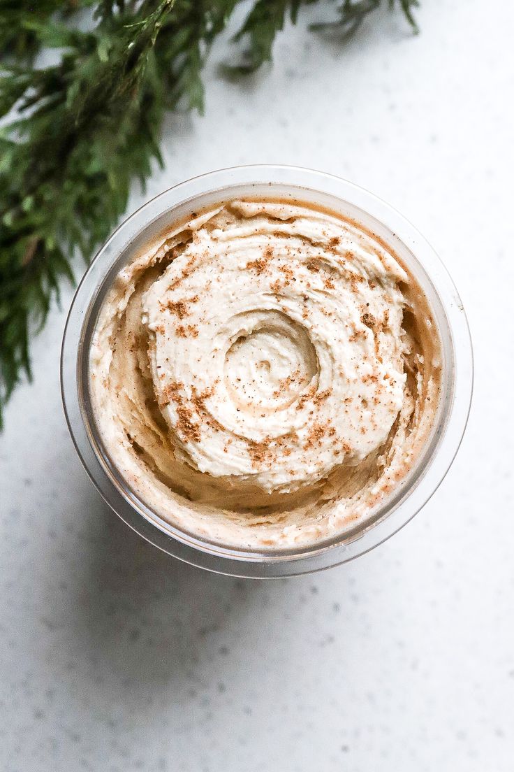 an overhead view of a cup of hummus with cinnamon sprinkled on top