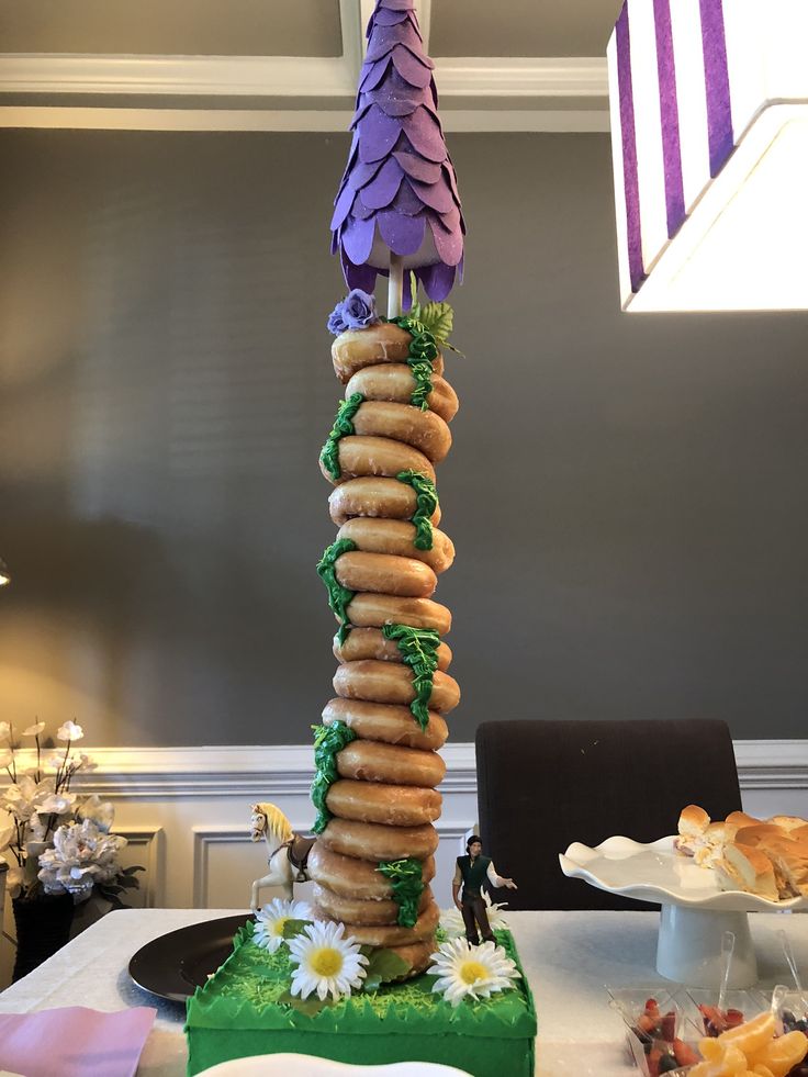 a tall tower of doughnuts sitting on top of a table