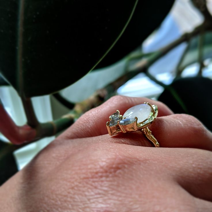 Moonstone, Labrodorite, and 14K Yellow Gold come together in this one of a kind statement ring. Organic texture abounds! A pretty cocktail ring for someone who likes to make a statement. One of a kind. Unique Yellow Gold Moonstone Ring, Unique Yellow Gold Moonstone Open Ring, Unique Yellow Gold Open Moonstone Ring, Elegant Natural Moonstone Promise Ring, Unique Gold Moonstone Ring With Rose Cut Diamonds, Unique Moonstone Ring With Rose Cut Diamonds, Promise Moonstone Open Ring, Unique Moonstone Ring With Rose Cut Diamonds As Gift, Heirloom Style Moonstone Open Ring