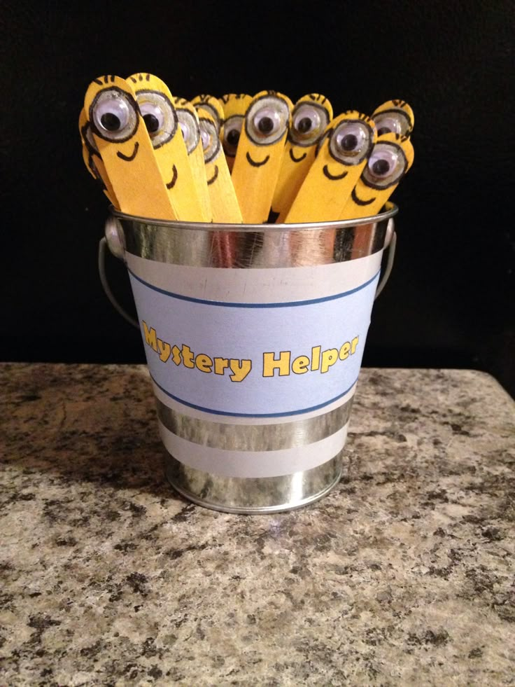 a bucket filled with yellow pencils sitting on top of a counter