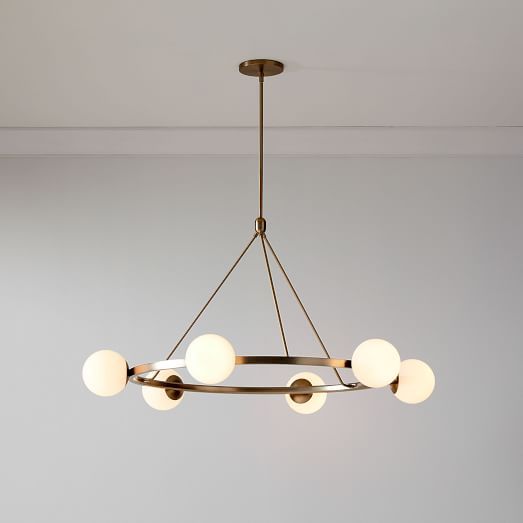 a chandelier hanging from the ceiling in a room with white walls and flooring